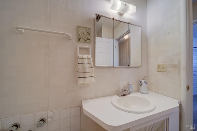 bathroom with tile walls and vanity