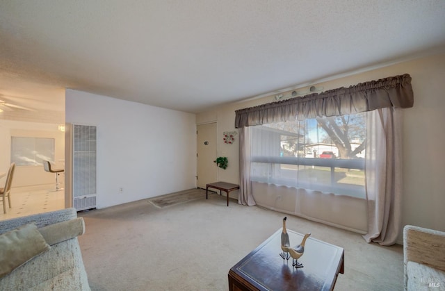 carpeted living room featuring ceiling fan