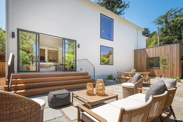 back of property with a patio area and an outdoor living space