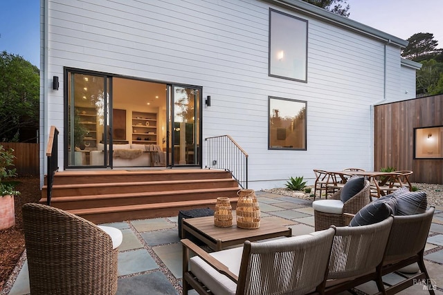 back of house with a patio and an outdoor living space