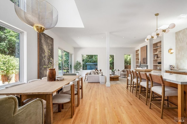 dining room featuring light hardwood / wood-style floors and built in shelves