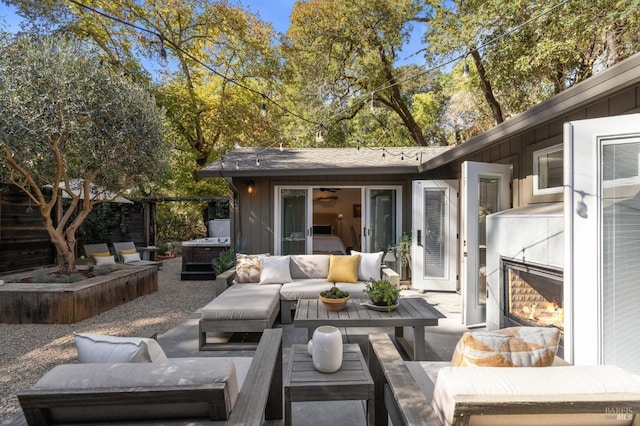 view of patio / terrace featuring a jacuzzi and an outdoor living space