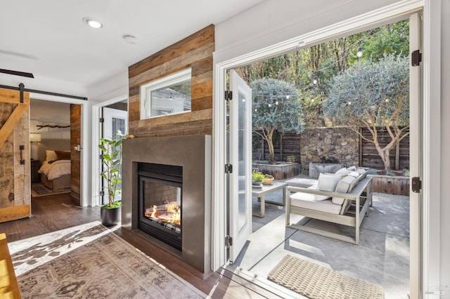 doorway featuring a fireplace, a barn door, and dark hardwood / wood-style flooring