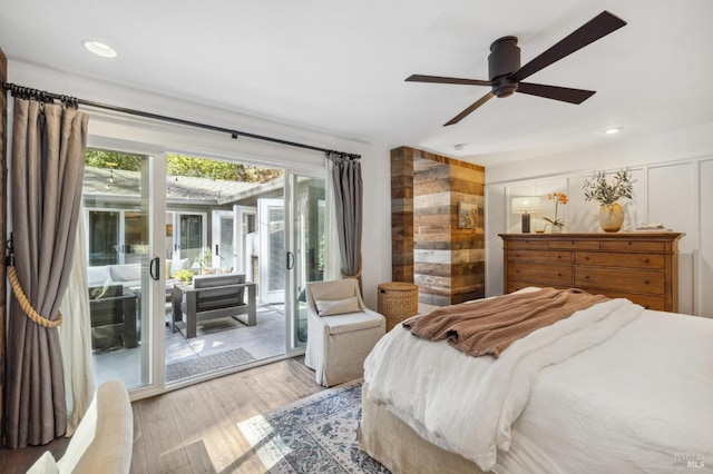 bedroom with ceiling fan, access to outside, and wood-type flooring