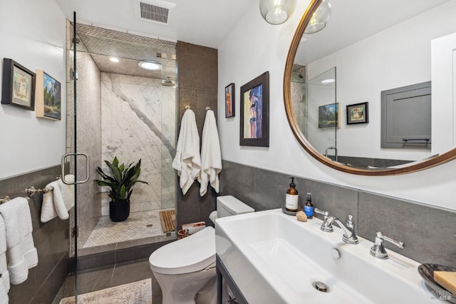 bathroom with sink, tile patterned flooring, toilet, and a shower with door