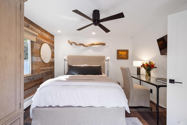 bedroom with dark wood-type flooring, ceiling fan, and baseboard heating