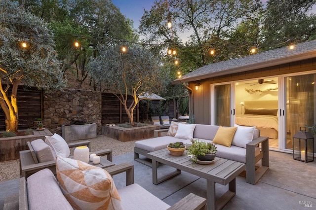 patio terrace at dusk featuring an outdoor living space