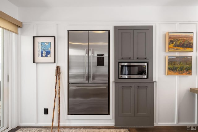 kitchen featuring gray cabinetry and built in appliances