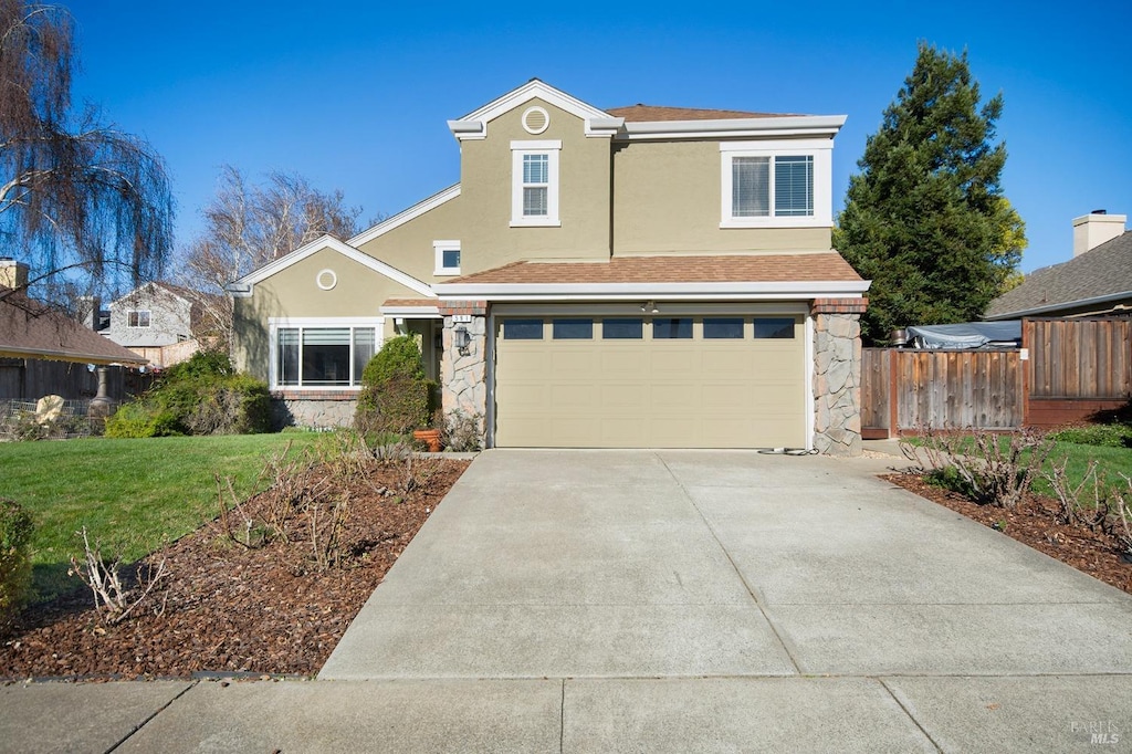 view of property with a front yard and a garage