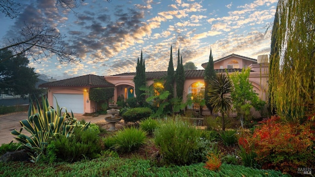 mediterranean / spanish house with a garage