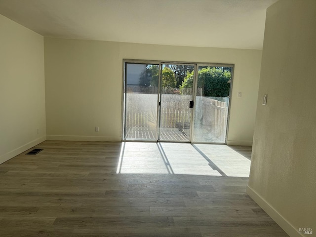 spare room with light hardwood / wood-style floors