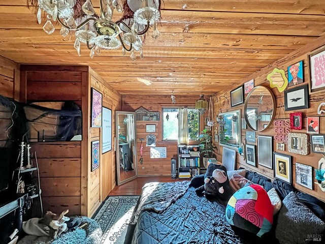 hall with lofted ceiling with beams, a barn door, wooden ceiling, stone tile floors, and wood walls