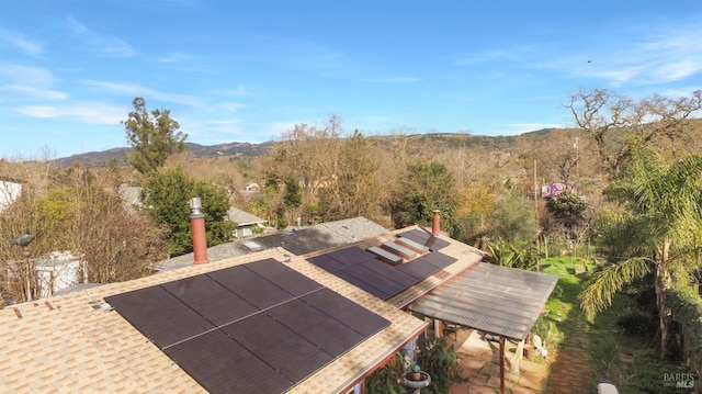 aerial view featuring a forest view and a mountain view