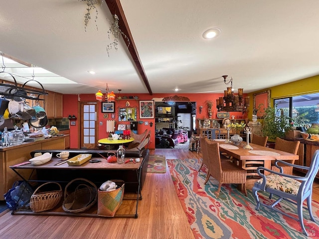 dining area with recessed lighting, a chandelier, beam ceiling, and wood finished floors