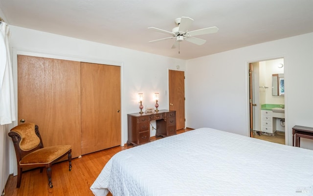 bedroom with connected bathroom, a closet, ceiling fan, and light wood-type flooring