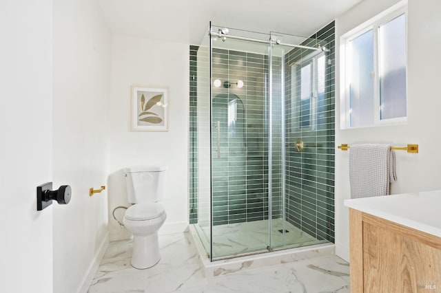 bathroom featuring toilet, marble finish floor, and a shower stall