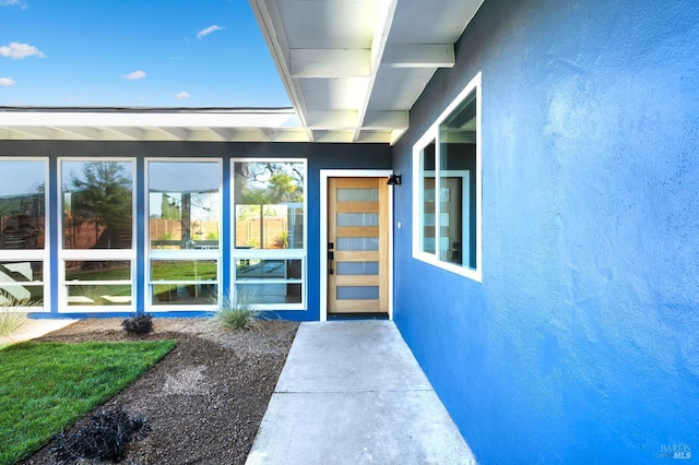 property entrance featuring stucco siding