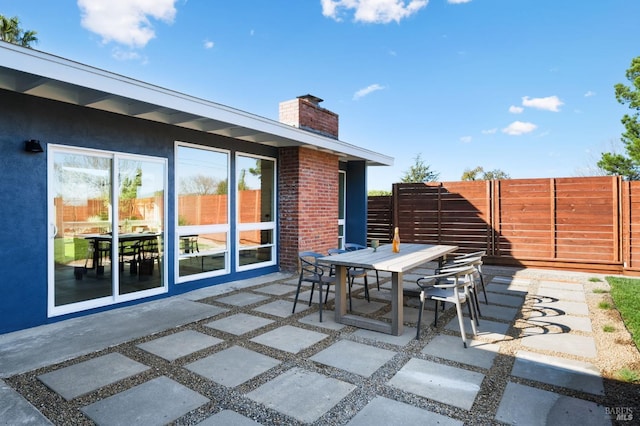 view of patio featuring fence and outdoor dining space