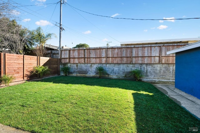 view of yard with a fenced backyard