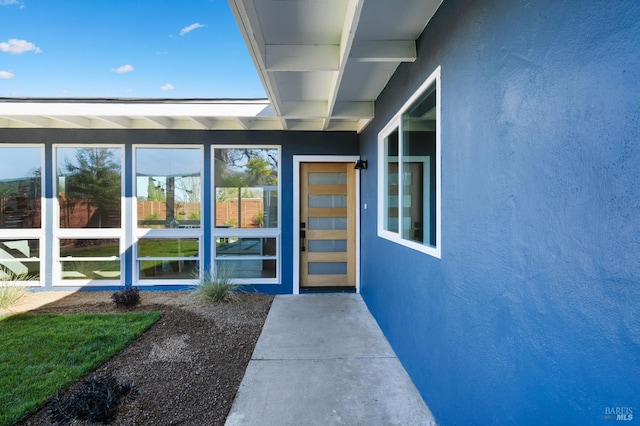 view of exterior entry with stucco siding