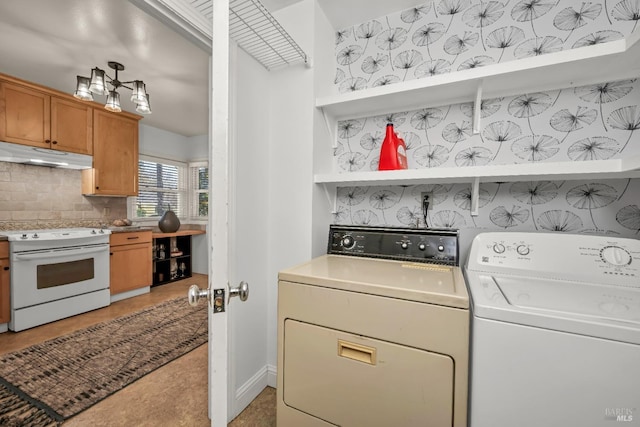 clothes washing area featuring laundry area and washing machine and dryer