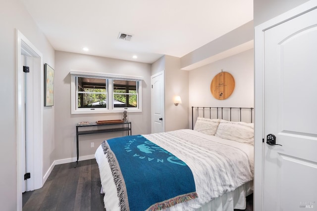 bedroom with dark hardwood / wood-style floors