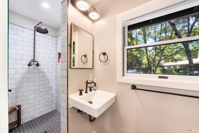 bathroom featuring a tile shower and sink