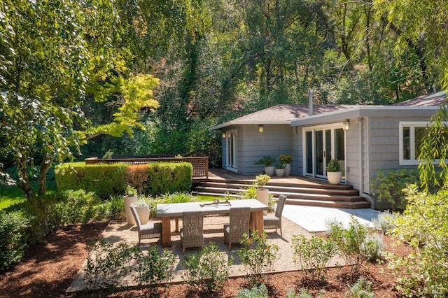 rear view of property with a patio and a deck