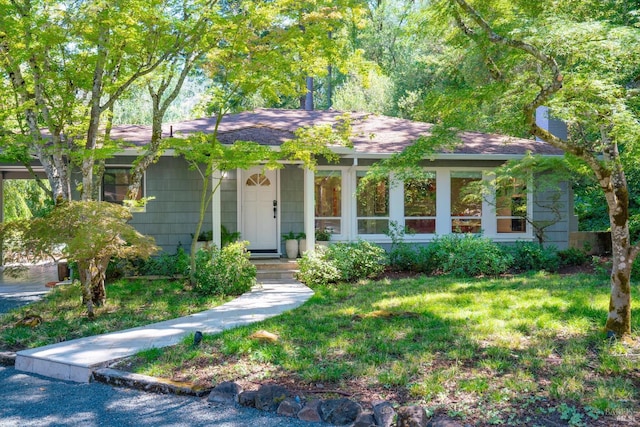 ranch-style house with a front lawn