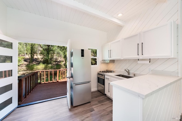 kitchen featuring sink, white cabinetry, light wood-type flooring, and appliances with stainless steel finishes