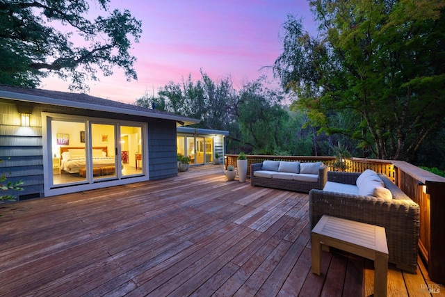 deck at dusk with an outdoor hangout area