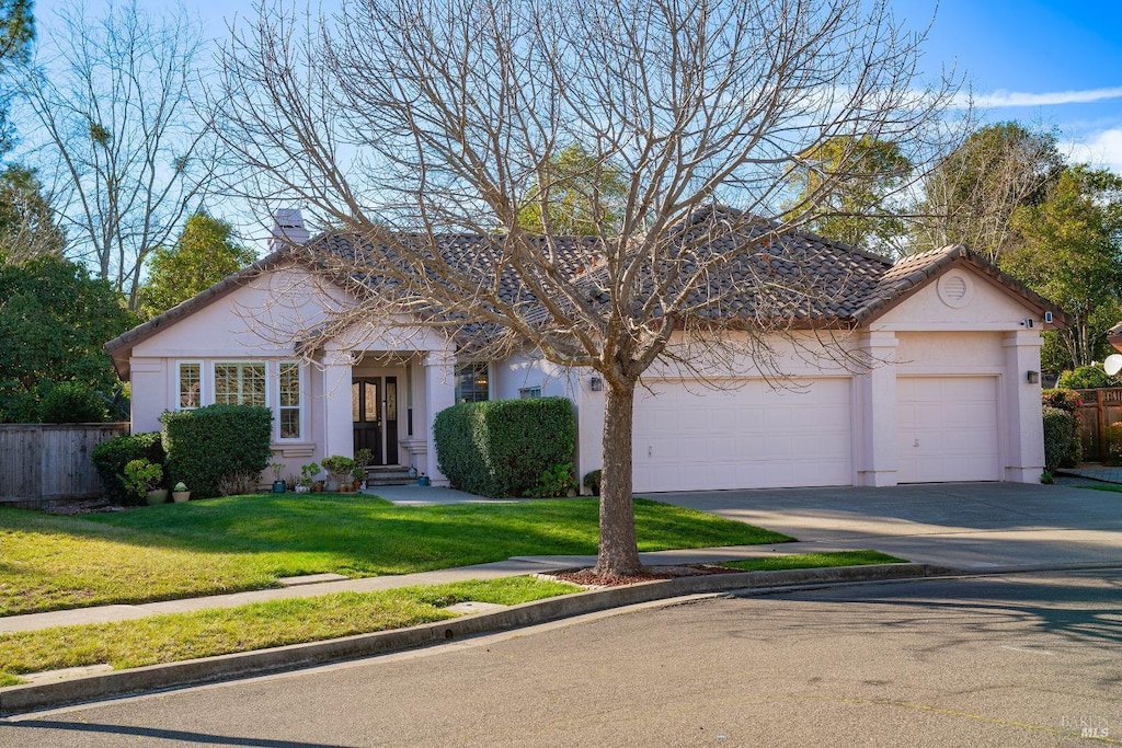 view of front of house featuring a front yard and a garage