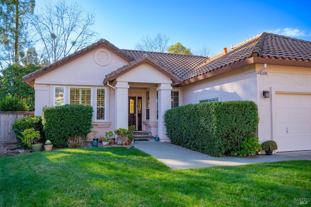 view of front of house featuring a garage and a front yard