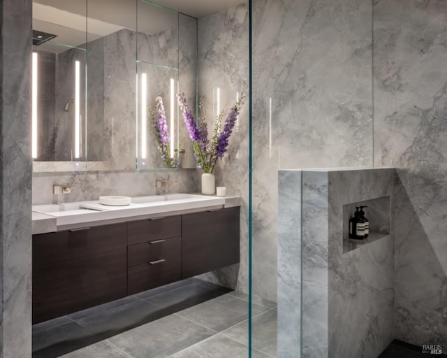 bathroom featuring walk in shower and vanity