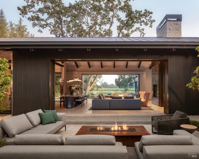 view of patio featuring an outdoor living space with a fire pit