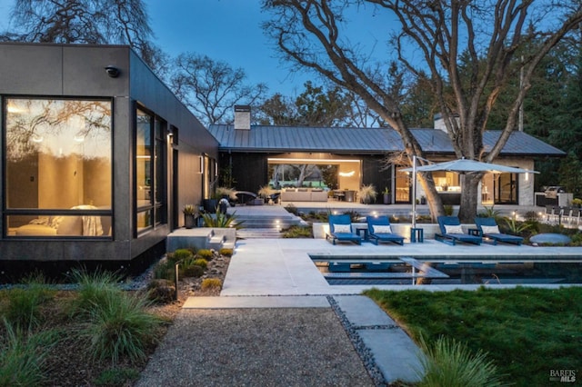 back of house featuring an outdoor hangout area and a patio area