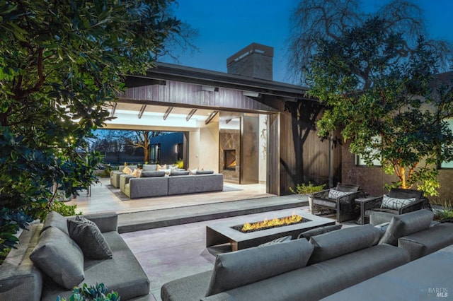 view of patio / terrace featuring an outdoor living space with a fire pit