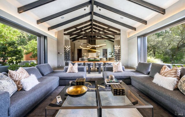 sunroom / solarium featuring vaulted ceiling with beams