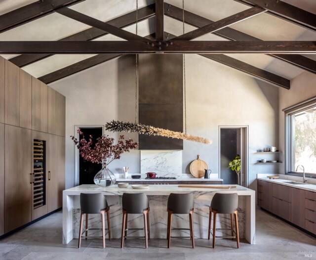 living room with high vaulted ceiling and beamed ceiling