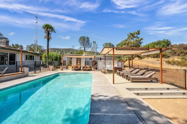 view of swimming pool with a patio area, fence, an outdoor hangout area, and a fenced in pool