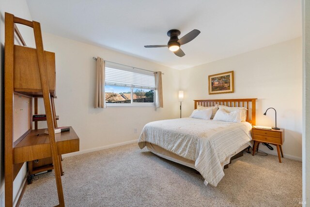 bedroom with ceiling fan and light colored carpet