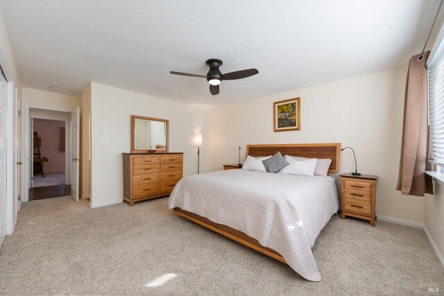 bedroom with ceiling fan and light colored carpet