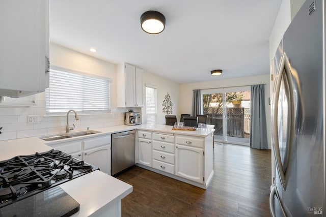 kitchen featuring white cabinetry, sink, kitchen peninsula, and stainless steel appliances