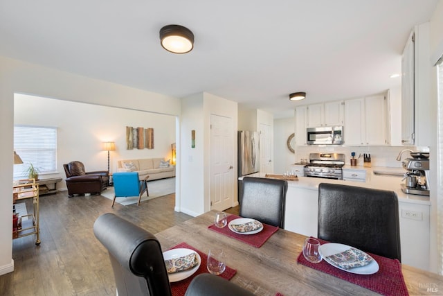 dining area with sink and light hardwood / wood-style flooring