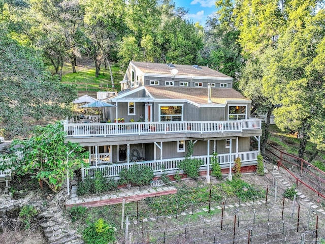 rear view of property featuring a deck