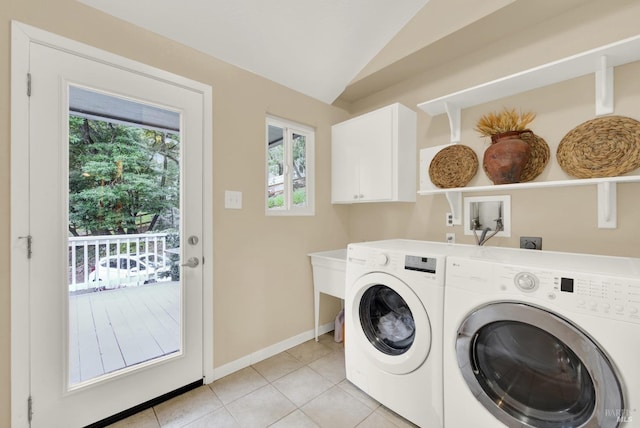 laundry room featuring washer and dryer, light tile patterned floors, and cabinets