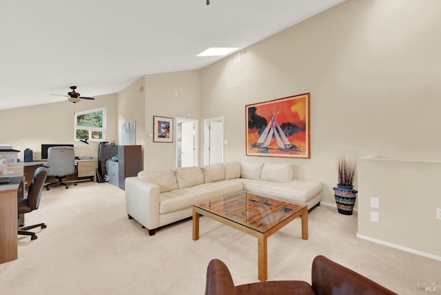 living room with light colored carpet and vaulted ceiling with skylight