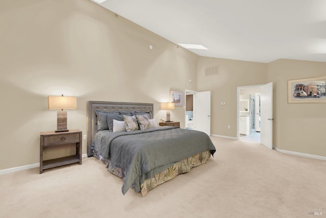 carpeted bedroom with lofted ceiling with skylight