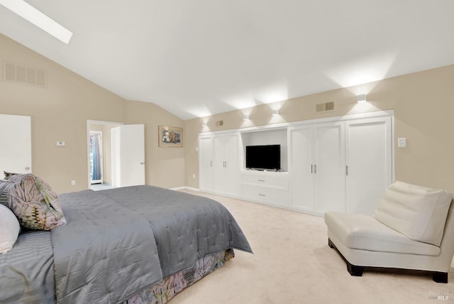 carpeted bedroom with vaulted ceiling with skylight