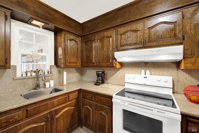 kitchen with light countertops, a sink, white electric range oven, and under cabinet range hood